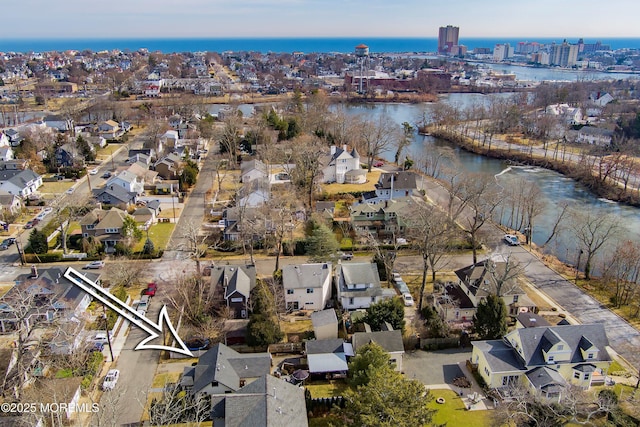 bird's eye view with a water view and a residential view