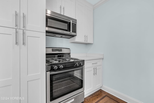 138 Summit Ave, Neptune City, NJ 07753 - kitchen with light countertops, appliances with stainless steel finishes, dark wood-style floors, and white cabinetry