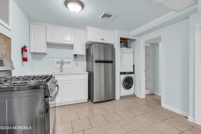 138 Summit Ave, Neptune City, NJ 07753 - kitchen featuring stacked washer and dryer, visible vents, a sink, light countertops, and stainless steel appliances