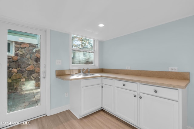 138 Summit Ave, Neptune City, NJ 07753 - kitchen with light wood-type flooring, a sink, white cabinetry, and light countertops