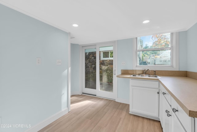 138 Summit Ave, Neptune City, NJ 07753 - kitchen with recessed lighting, light countertops, white cabinets, a sink, and light wood finished floors