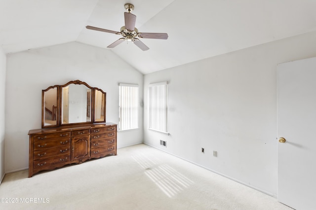 bedroom with light carpet, vaulted ceiling, visible vents, and ceiling fan