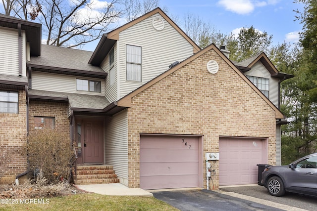 view of front of house featuring entry steps, brick siding, roof with shingles, and an attached garage