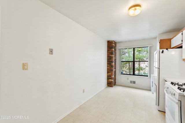 kitchen with white appliances, visible vents, white cabinets, light countertops, and light floors