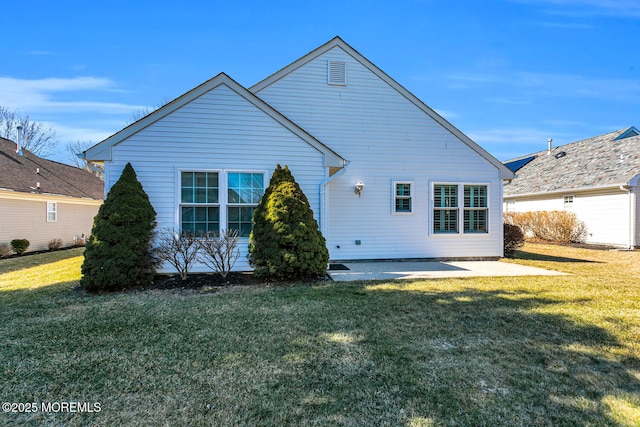 rear view of house featuring a patio area and a lawn