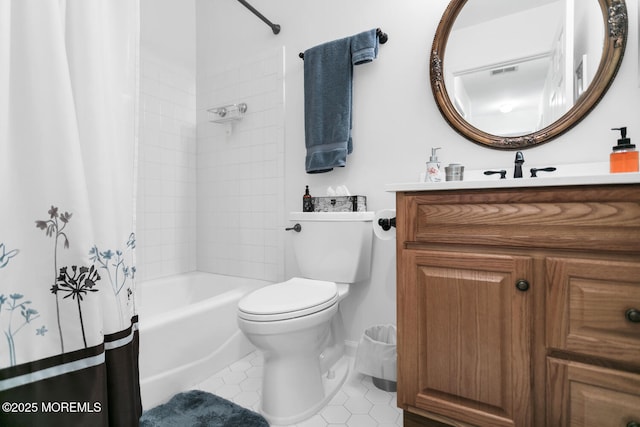 bathroom featuring toilet, vanity, baseboards, tile patterned floors, and shower / bath combo with shower curtain