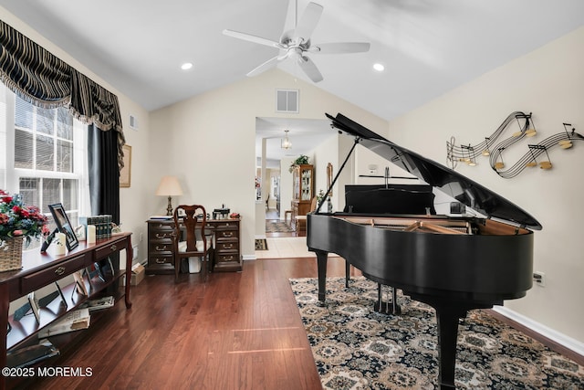 living area featuring lofted ceiling, baseboards, visible vents, and wood finished floors