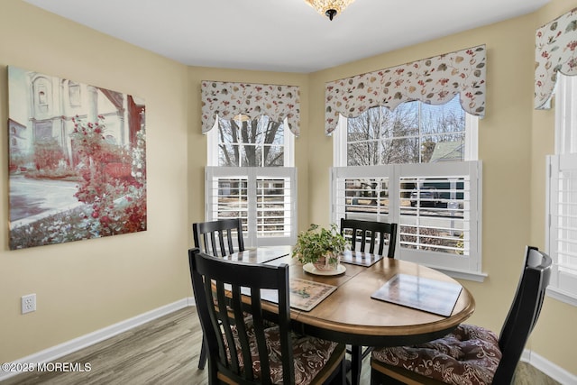 dining area with wood finished floors and baseboards