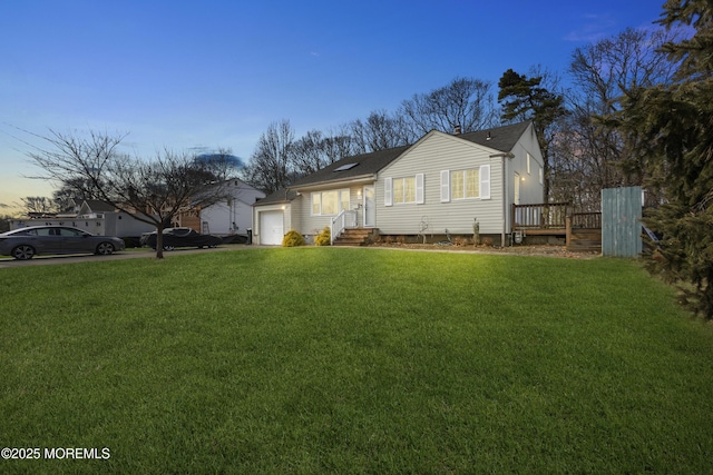 view of front of property featuring a yard and an attached garage