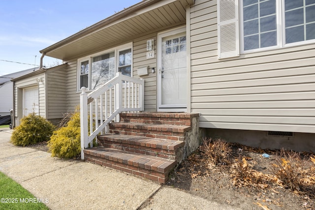 doorway to property with a garage and crawl space