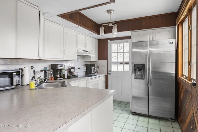 kitchen featuring stainless steel appliances, pendant lighting, white cabinets, and under cabinet range hood