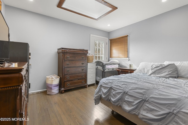 bedroom with dark wood-style floors, baseboards, a skylight, and recessed lighting