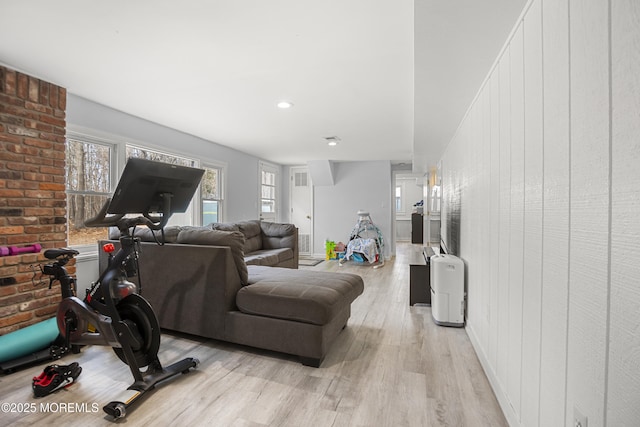 living area with light wood-type flooring and baseboards