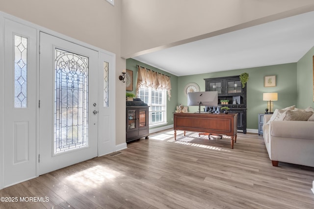 entryway featuring visible vents, light wood-style flooring, and baseboards