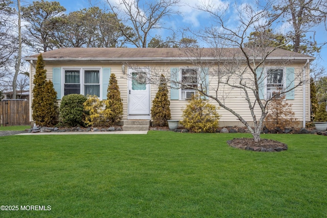 view of front of house with fence and a front yard