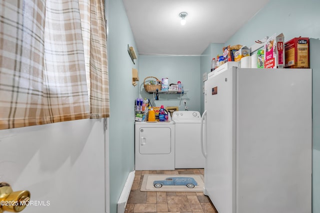 laundry area with laundry area, independent washer and dryer, and stone finish flooring