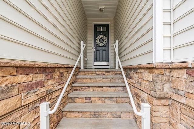 view of exterior entry featuring stone siding