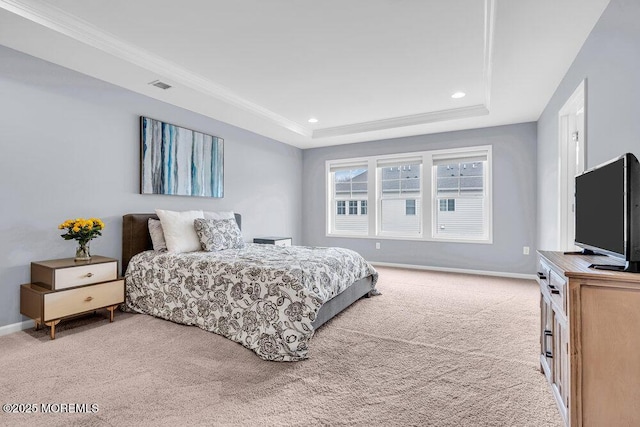 bedroom featuring light colored carpet, a tray ceiling, visible vents, and baseboards