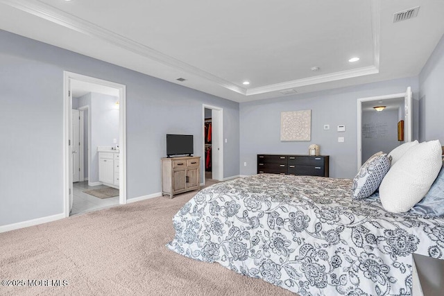 bedroom featuring carpet, a raised ceiling, visible vents, and a spacious closet