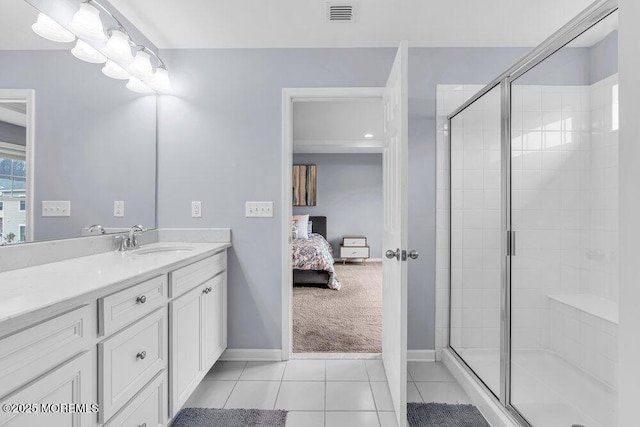 bathroom featuring connected bathroom, vanity, visible vents, a shower stall, and tile patterned floors