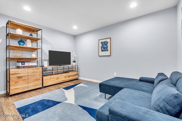 living area featuring recessed lighting, baseboards, and wood finished floors