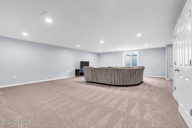 living room with recessed lighting, light carpet, and baseboards