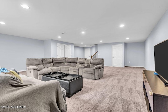 living room featuring recessed lighting, light carpet, visible vents, baseboards, and stairs