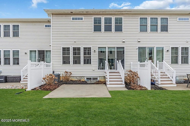 back of house featuring cooling unit, a yard, and a patio