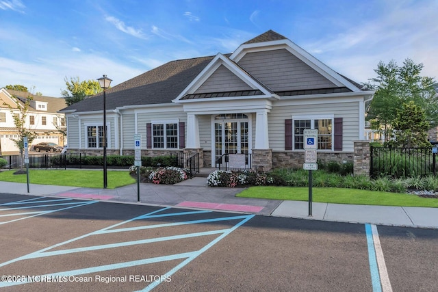 view of property featuring uncovered parking and fence