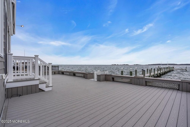 deck with a water view and a boat dock