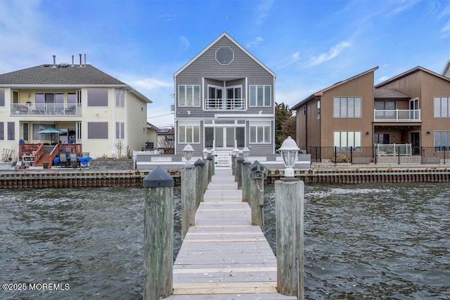 dock area featuring a water view and a balcony