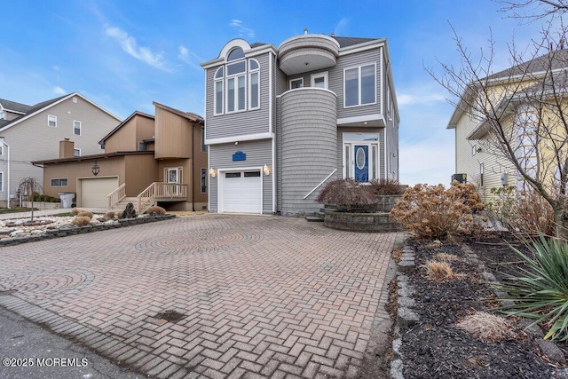 view of front of property featuring decorative driveway and an attached garage