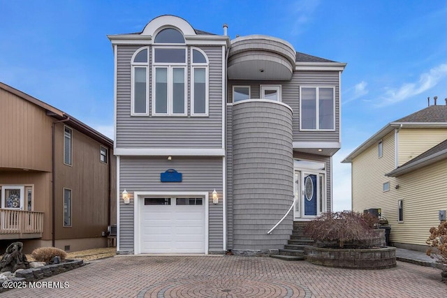 view of front of house featuring a garage and decorative driveway