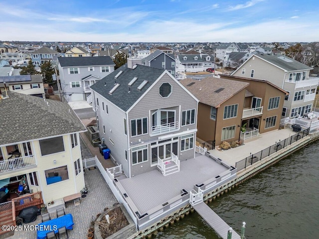 drone / aerial view featuring a water view and a residential view