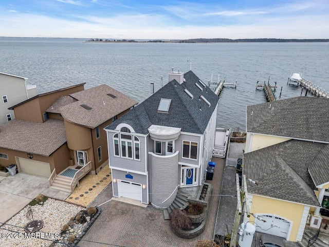 birds eye view of property with a water view