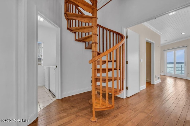 stairway featuring crown molding, baseboards, and hardwood / wood-style flooring