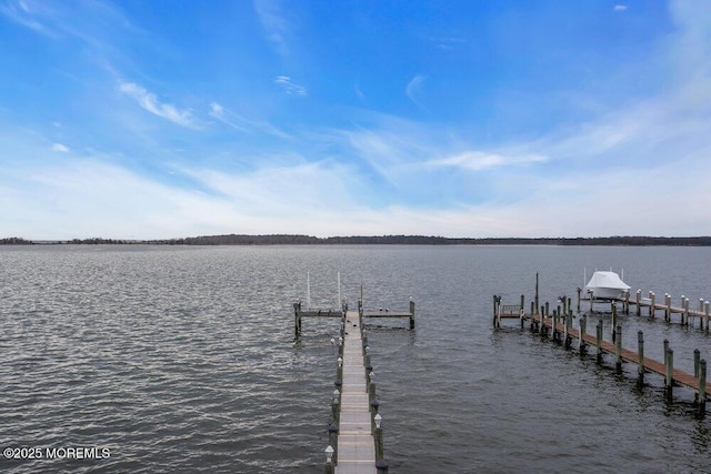 dock area with a water view and boat lift