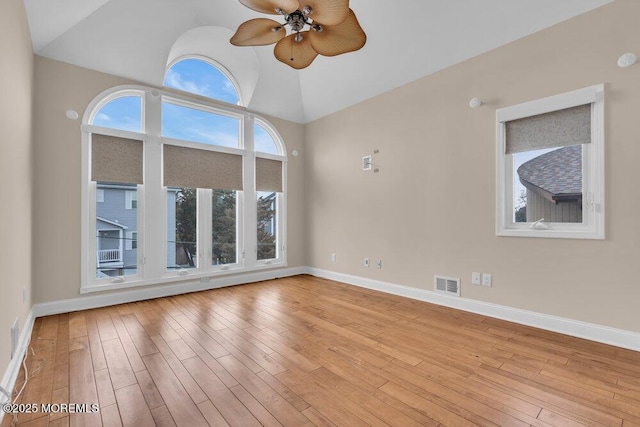 spare room with a ceiling fan, baseboards, visible vents, and hardwood / wood-style floors