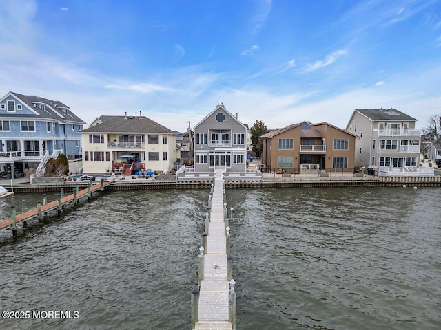 dock area featuring a water view and a residential view