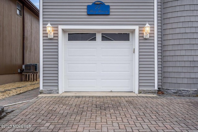 garage with decorative driveway