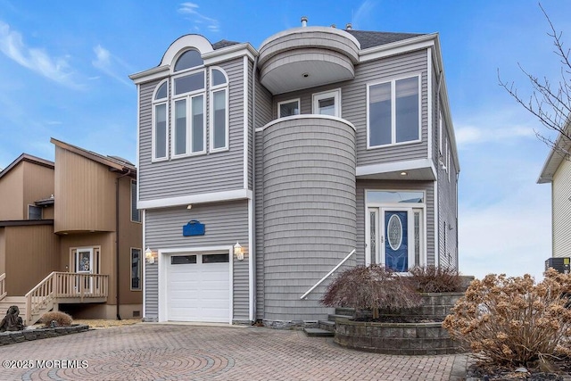 view of front facade with an attached garage and decorative driveway