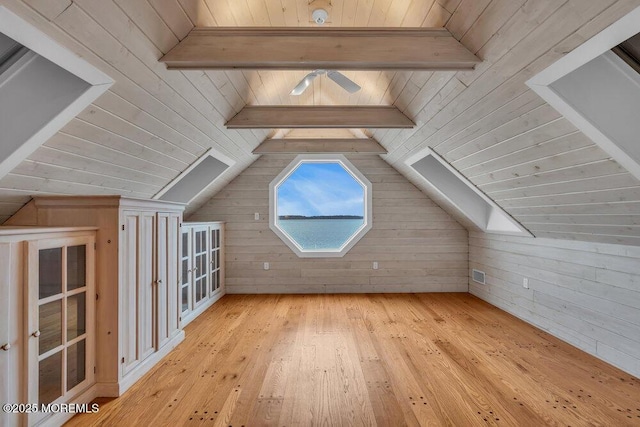 bonus room featuring vaulted ceiling with beams, wood walls, and wood-type flooring