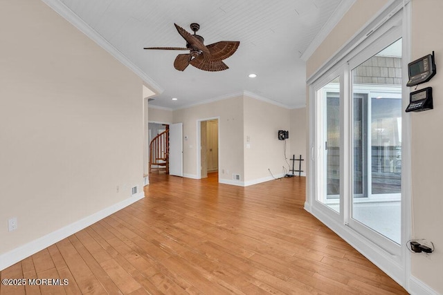 interior space with baseboards, ornamental molding, stairway, and light wood-style floors