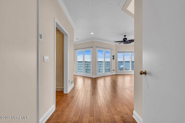 hallway with baseboards, recessed lighting, light wood-type flooring, and crown molding