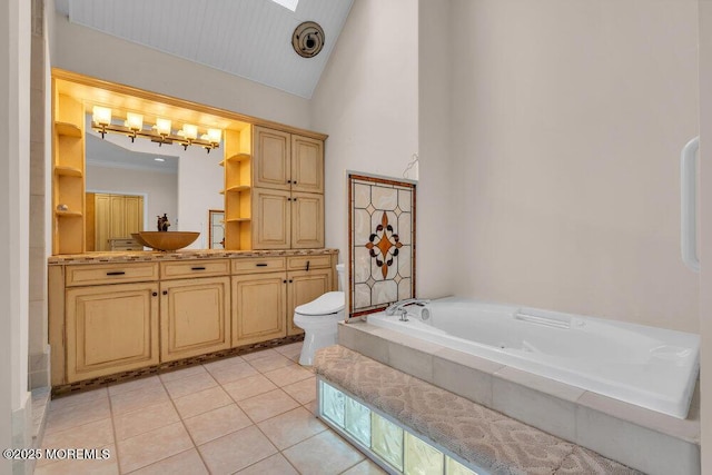 full bath with a garden tub, lofted ceiling, toilet, vanity, and tile patterned flooring