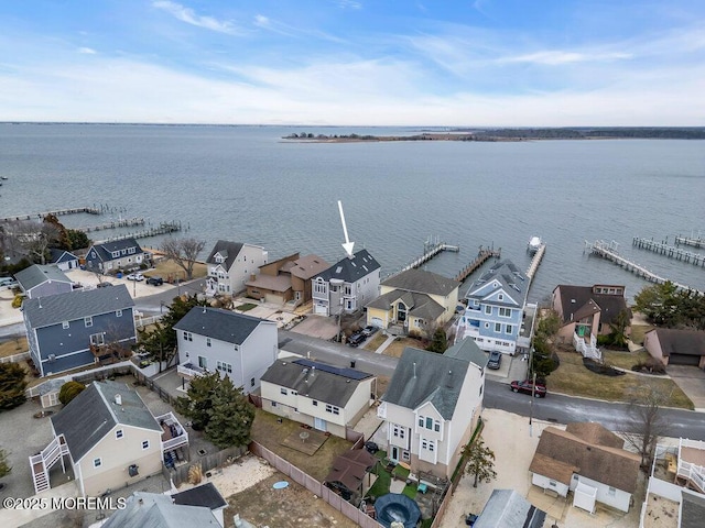 drone / aerial view featuring a residential view and a water view