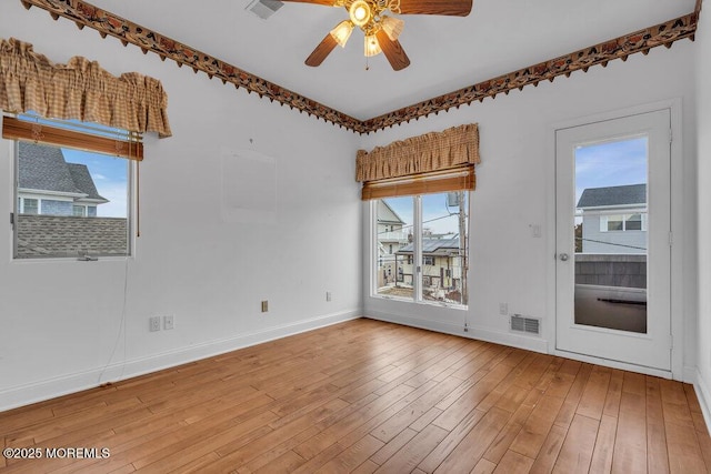 unfurnished room featuring visible vents, ceiling fan, light wood-style flooring, and baseboards