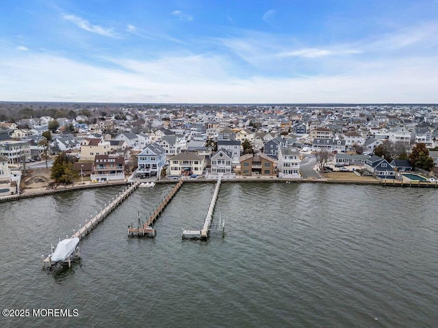 drone / aerial view with a water view and a residential view