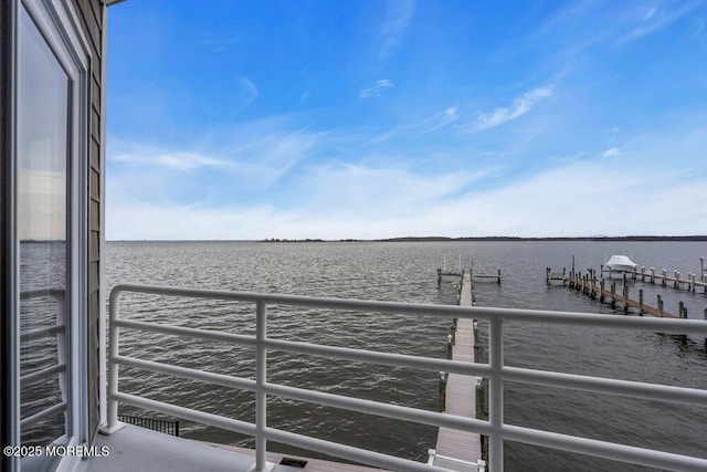 dock area featuring a water view and a balcony