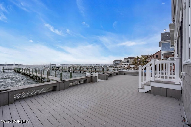 wooden terrace with a water view and a dock